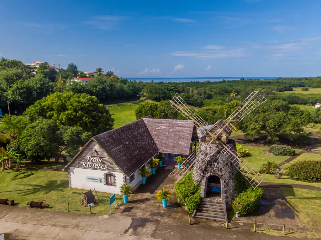 The Trois-Rivières rum estate with its stone windmill and green grounds in Martinique