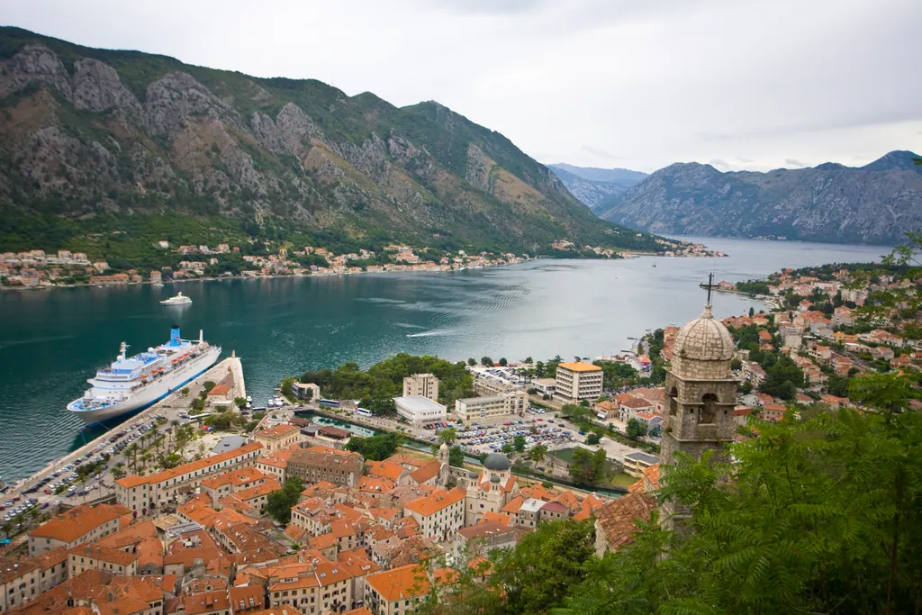 View from the fortress above Kotor over the red roofs of the old town and the calm Bay of Kotor framed by mountains