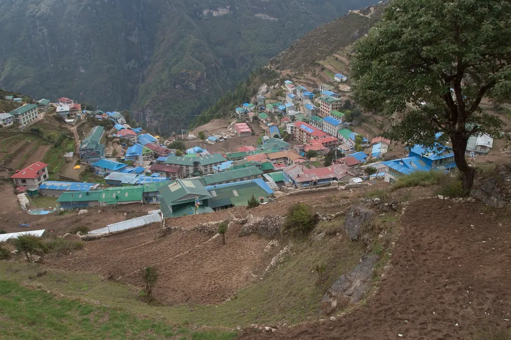 Namche Bazaar's colorful roofs stacked in a horseshoe on the mountainside