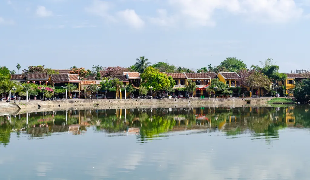 The yellow riverfront houses of Hoi An's old town reflected in the Thu Bon River