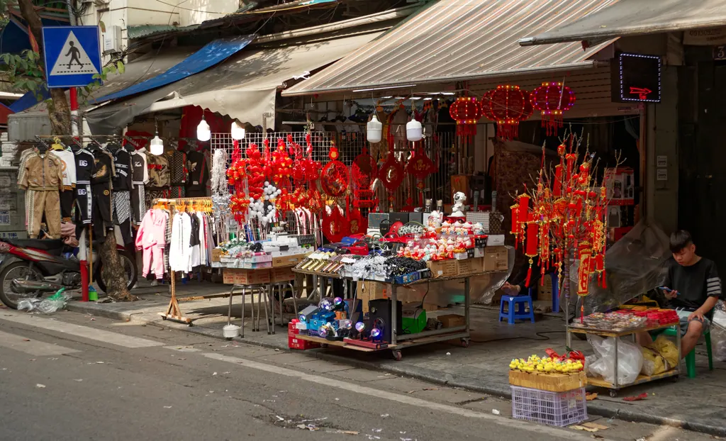 A street shop in Hanoi's Old Quarter decorated with red lanterns and clothing racks