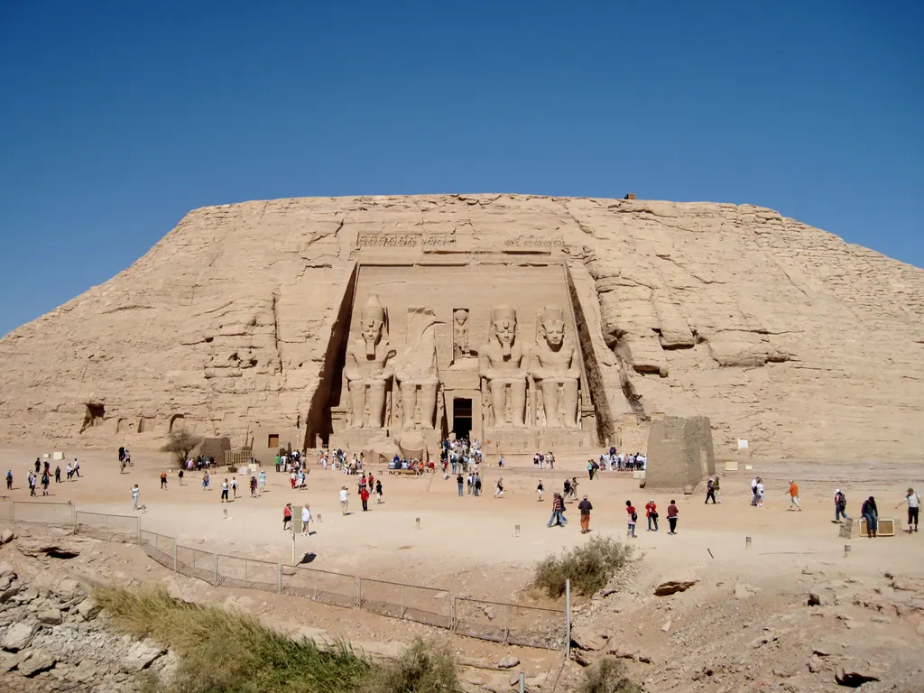 The Great Temple of Abu Simbel with four colossal seated statues of Ramesses II cut into the sandstone cliff