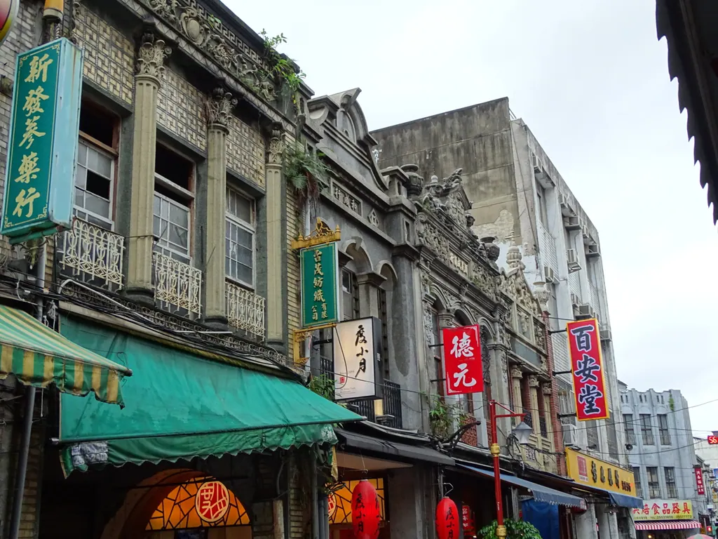 Restored historic shophouse facades with shop signs and awnings on Dihua Street in Taipei