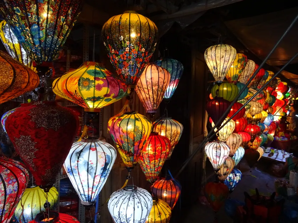 Colorful glowing silk lanterns hanging in a lantern shop in Hoi An
