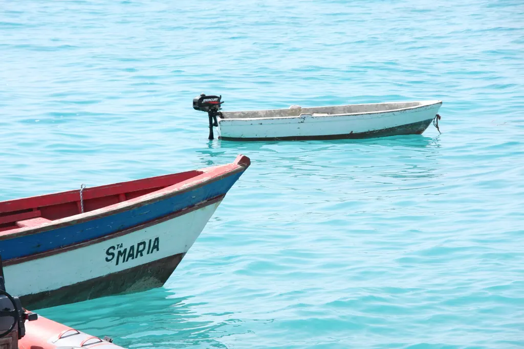 Two colorful fishing boats on clear turquoise water off Santa Maria on the island of Sal