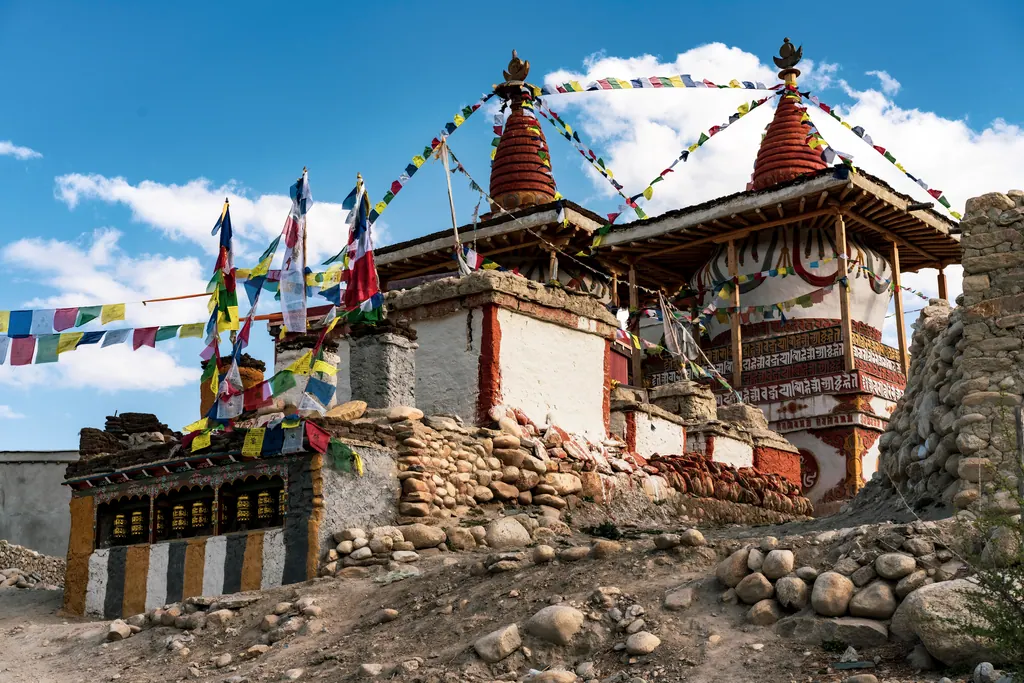 A whitewashed chorten with red spires and prayer flags near Lo Manthang in Upper Mustang
