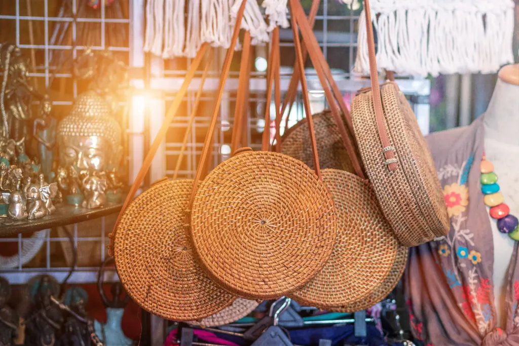 Round woven rattan bags hanging at a street shop in Bali